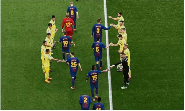  ?? — AP ?? Hail the champions: Villarreal players (in yellow) forming a guard of honour for Barcelona players before the La Liga match at the Nou Camp on Wednesday.
