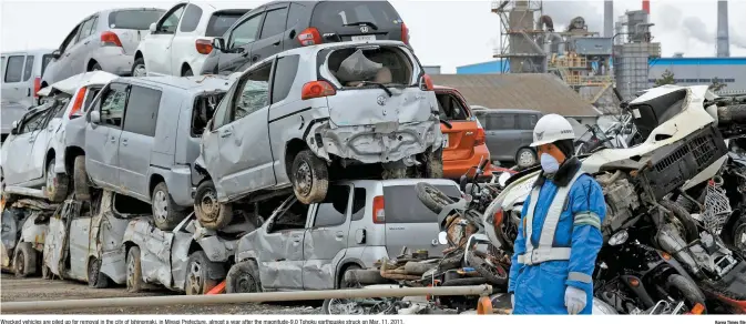  ?? Korea Times file ?? Wrecked vehicles are piled up for removal in the city of Ishinomaki, in Miyagi Prefecture, almost a year after the magnitude-9.0 Tohoku earthquake struck on Mar. 11, 2011.