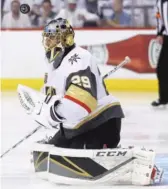  ?? AP ?? Golden Knights goalie Marc- Andre Fleury makes a save with his helmet during the second period.