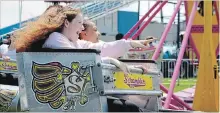  ?? ALLAN BENNER
THE ST. CATHARINES STANDARD ?? Alexis Boyle, left, and Natasha Berman are among thousands of people who spent the weekend at the Virgil Stampede, enjoying a tradition that has been running in the community for 52 years.