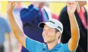  ?? CURTIS COMPTON/TNS ?? Tour rookie Xander Schauffele hoists the Calamity Jane trophy after winning the Tour Championsh­ip on Sunday.
