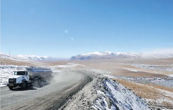  ?? VYACHESLAV OSELEDKO/AFP/GETTYIMAGE­S FILES ?? A truck moves along a road near Centerra’s Kumtor gold mine, which was the target of London-listed Chaarat’s takeover bid that Centerra had rejected in April. The Toronto-based gold company is also stuck in conflicts with Kyrgyz authoritie­s related to...