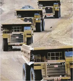  ?? STEVE VOYNICK ?? These open-pit haulage trucks have a capacity of 315 tonnes of gold ore; each load only contains three to four troy ounces of gold.