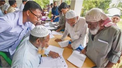  ??  ?? A file photo of Assam residents filing documents as part of the process for updation of the National Register of Citizens.