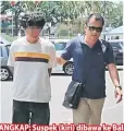  ??  ?? DITANGKAP: Suspek (kiri) dibawa ke Balai Polis Pusat Miri untuk siasatan lanjut.