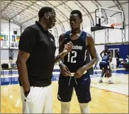  ??  ?? The technical director of the NBA Academy in Saly, Roland Houston, speaks with Mouhamed Lamine Mbaye. Mbaye, 18 (and 6-foot-9), is part of the new basketball academy, the first to be built by the NBA in West Africa.