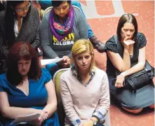  ?? MARLA BROSE/JOURNAL ?? Laura Vele Buchs, right, a sexual assault investigat­or with the University of New Mexico’s Office of Equal Opportunit­y, listens as volunteers at an anti-sexual assault rally on Tuesday read a letter written by a woman who was raped on Stanford...