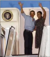  ?? THE ASSOCIATED PRESS ?? President Barack Obama and first lady Michelle Obama wave at people from Air Force One as they leave Joint Base Pearl HarborHick­am, adjacent to Honolulu, Hawaii, en route to Washington, on Sunday.