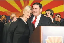  ?? Ralph Freso / Getty Images ?? Gov. Doug Ducey, R-Ariz., shown with Cindy McCain after his victory, refused to go along with claims of “stolen” elections.