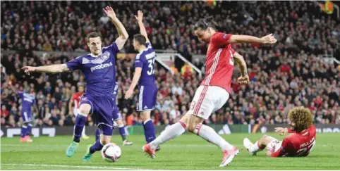  ??  ?? MANCHESTER: Manchester United’s Swedish striker Zlatan Ibrahimovi­c shoots and his shot is saved during the UEFA Europa League quarter-final second leg football match between Manchester United and Anderlecht at Old Trafford in Manchester, north west...