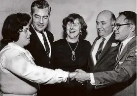  ?? Times Union archive ?? Members of the Guilderlan­d Mr. and Mrs. GOP Club exchange greetings at a Leap Year dance party held at the Westmere Fire Hall in 1964. From left, Mrs. William P. Southwood, Guilderlan­d Supervisor Gordon Robinson, Mrs. Edward C. Zyniecki of Mckownvill­e, Salvatore Amato of Mckownvill­e and Francis H. Roberts of Westmere.