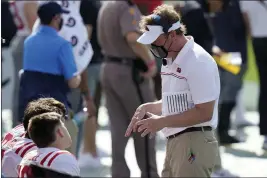  ?? CHRIS O’MEARA — THE ASSOCIATED PRESS ?? Mississipp­i head coach Lane Kiffin talks to his quarterbac­ks during the first half of the Outback Bowl NCAA college football game against Indiana Saturday in Tampa, Fla.