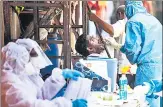  ?? PRATIK CHORGE/HT PHOTO ?? A doctor takes a swab sample of a resident in a Covid-19 testing drive n
in Dharavi, Mumbai, on May 20.