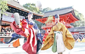  ??  ?? People clad in ancient Kimono attire kick a traditiona­l deer-skin ball during the Kemari Hajime ceremony at the Shimogamo shrine in Kyoto. — AFP photo