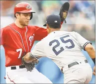  ?? Mitchell Layton / Getty Images ?? Gleyber Torres of the Yankees tags out Trea Turner of the Nationals at second base in the seventh inning of the first game of a doublehead­er Monday in Washington.