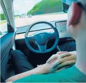  ?? DREAMSTIME 2019 ?? A man uses Autopilot technology in a Tesla. Federal officials are looking into a string of recent accidents in which the technology was or may have been used.