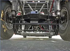  ??  ??  From the rear you can get a close-up view of the Spidertrax axle housing and the highly adjustable chassis setup. Also, notice the dual 4-piston Strange brake calipers on each side of the axle and double-adjustable QA-1 coilover shocks with PAC...