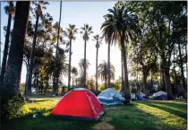  ?? SARAH REINGEWIRT­Z — STAFF PHOTOGRAPH­ER ?? Tents are seen at Echo Park Lake in Los Angeles in 2021 as the city and homeless services prepares to close down the homeless encampment and close the park for repairs.