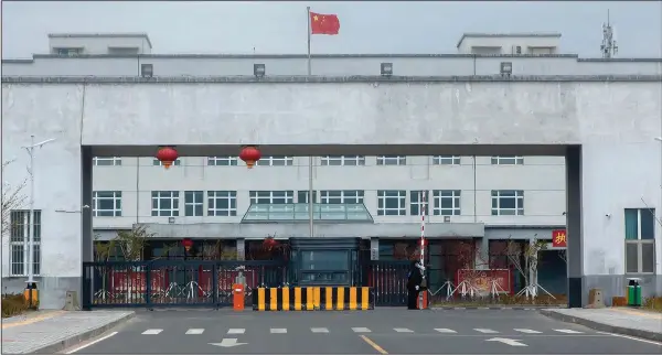  ?? (File Photo/AP/Mark Schiefelbe­in) ?? Police officers stand April 23, 2021, at the outer entrance of the Urumqi No. 3 Detention Center in Dabancheng in western China’s Xinjiang Uyghur Autonomous Region. State officials took AP journalist­s on a tour of a “training center” turned detention site in Dabancheng sprawling over 220 acres and estimated to hold at least 10,000 prisoners — making it by far the largest detention center in China and among the largest on the planet.