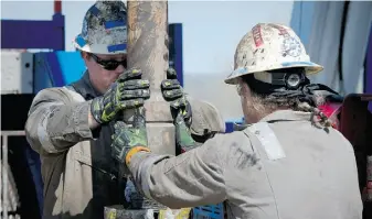  ?? MLADEN ANTONOV/AFP/GET TY IMAGES/FILES ?? Workers change pipes at the Consol Energy horizontal gas drilling rig near Waynesburg, Pa. Advances in extracting oil from shale rock have driven a big jump in U.S. production.