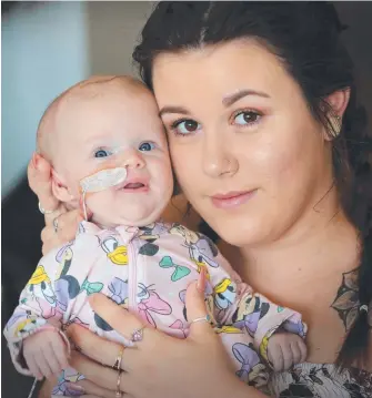  ?? Picture: JAMIE HANSON ?? Mum Emily Kouimanis and partner Liam Christense­n were able to bring their nine-week-old baby Violet, who has a rare brain tumour, home for Christmas.