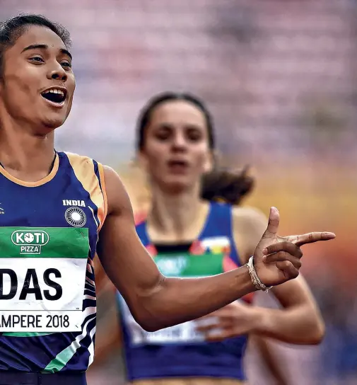  ??  ?? IT’S GOLD Hima Das, after winning the 400 m in Tampere