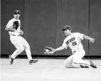  ?? NATI HARNIK/ASSOCIATED PRESS ?? UF center fielder Nick Horvath (26) slides to make a catch during the fifth inning of Sunday’s game against Texas Tech.