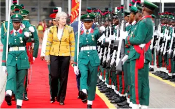  ??  ?? May inspects a Guard of Honour as she arrives in Abuja, Nigeria. — Reuters photo