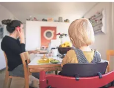  ?? FOTO: CHRISTIAN BEUTLER/DPA ?? Eine Frau sitzt mit ihrem Kind im Homeoffice.