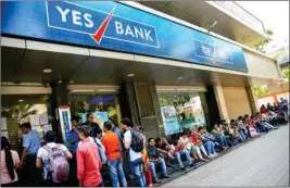  ?? PTI ?? Account holders queue up outside Yes Bank to withdraw money, in Mumbai on Saturday