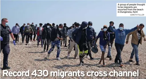  ?? GARETH FULLER ?? A group of people thought to be migrants are escorted from the beach in Dungeness, Kent