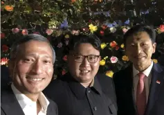  ??  ?? A photo taken from social network Twitter’s account of Balakrishn­an shows him (left) posing for a picture with North Korean leader Kim Jong-Un (centre) during a tour in Singapore. — AFP photo