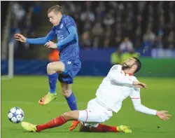  ?? The Associated Press ?? Leicester’s Jamie Vardy, left, competes for the ball against Sevilla’s Adil Rami during a Champions League soccer match Tuesday in Leicester, England.
