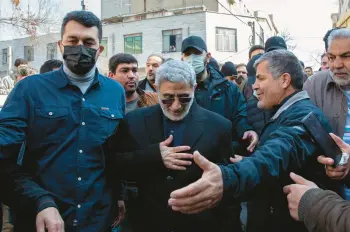  ?? ARASH KHAMOOSHI/THE NEW YORK TIMES ?? Brig. Gen. Esmail Ghaani, center, seen Feb. 4 in Tehran, leads Iran’s Quds Forces.