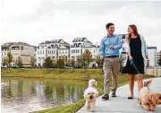  ??  ?? This picturesqu­e community is complement­ed by amenities including a gated entrance, serene water features, walkable streetscap­es and several dog parks.