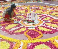  ?? — AFP ?? A woman decorates the Bangladesh Central Language Martyrs’ Memorial monument with flowers in homage to the martyrs of the 1952 Bengali Language Movement in Dhaka on Internatio­nal Mother Language Day. Internatio­nal Mother Language Day is celebrated each...