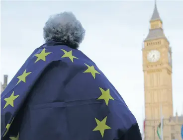  ?? DANIEL LEAL- OLIVAS / AFP / GETTY IMAGES FILES ?? A protester draped in a European Union flag takes part in a London demonstrat­ion in March in support of an amendment to guarantee legal status of EU citizens.