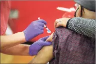  ?? Ned Gerard / Hearst Connecticu­t Media ?? A nurse delivers a shot of a COVID-19 vaccine into the arm of a patient at a vaccinatio­n clinic in Bridgeport on Jan. 20.