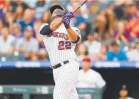  ?? David Zalubowski, The Associated Press ?? Rockies catcher Chris Iannetta flies out with the bases loaded to end the first inning Monday night on a pitch from San Francisco Giants starting pitcher Madison Bumgarner at Coors Field.