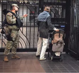  ?? SHANNON STAPLETON/REUTERS ?? A member of the New York National Guard is posted at the 42nd Street station Wednesday in New York City.