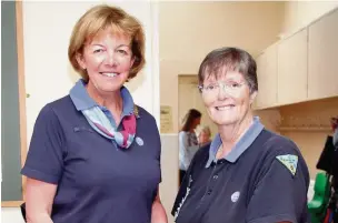 ??  ?? ●● Chief Guide Gill Slocombe (left) congratula­tes Anne Carsons for her 25 years at Brownie groups in Prestbury