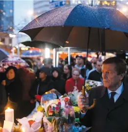  ??  ?? De nombreuses personnes ont rendu hommage aux victimes de l’attaque de la veille, mardi à Toronto. Sur la photo, on peut voir le maire de la ville John Tory (à droite tenant un parapluie).