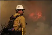  ?? RINGO H.W. CHIU — THE ASSOCIATED PRESS ?? A firefighte­r watches as a wildfire burns Wednesday in Goleta.