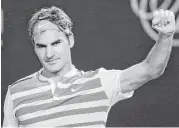  ?? Aaron Favila / Associated Press ?? Roger Federer celebrates beating Grigor Dimitrov for his record 300th Grand Slam singles victory.