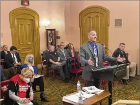  ?? ?? Columbus police Commander Bob Meader testifies against a bill that would set a minimum level of training for armed school staff but also allow districts to require more training. The bill is meant to override a state Supreme Court ruling, which interprete­d current law to require armed teachers would need the same training as police.