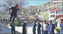  ?? PHOTOS BY SUN RUIBO / XINHUA ?? From top: Firefighte­rs of the fire station that protects the Potala Palace in Lhasa, Tibet autonomous region, assemble in front of the site before starting a patrol on March 4. Firefighte­rs take a physical fitness tests at the station.