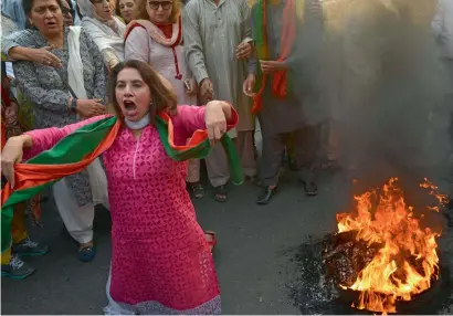  ?? AFP ?? Activists of the Pakistan Tehreek-i-Insaf raise slogans during a protest in Lahore on Friday. —