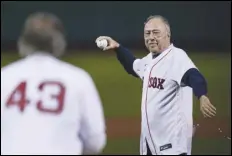  ?? ASSOCIATED PRESS FILES ?? Former Boston Red Sox player Jerry Remy, wearing an oxygen tube, throws a ceremonial first pitch to former Red Sox pitcher Dennis Eckersley before last month’s American League Wild Card baseball game against the New York Yankees in Boston. Remy died, Saturday, at age 68.