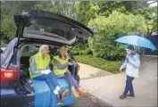  ?? Allen J. Schaben Los Angeles Times ?? FLO CHAPGIER, left, and Yolanda Bergman take cover as they chat with Laurie La Shelle during an evacuation drill in Mandeville Canyon on Sunday.