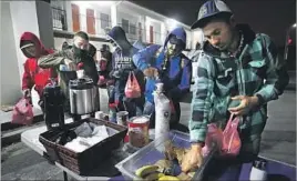  ??  ?? WORKERS ARE fed breakfast at 5:20 a.m. by owners of Norma’s Family Restaurant in Salinas before boarding a bus to pick produce in the surroundin­g area.